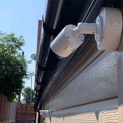 A modern cctv camera on the side of a home
